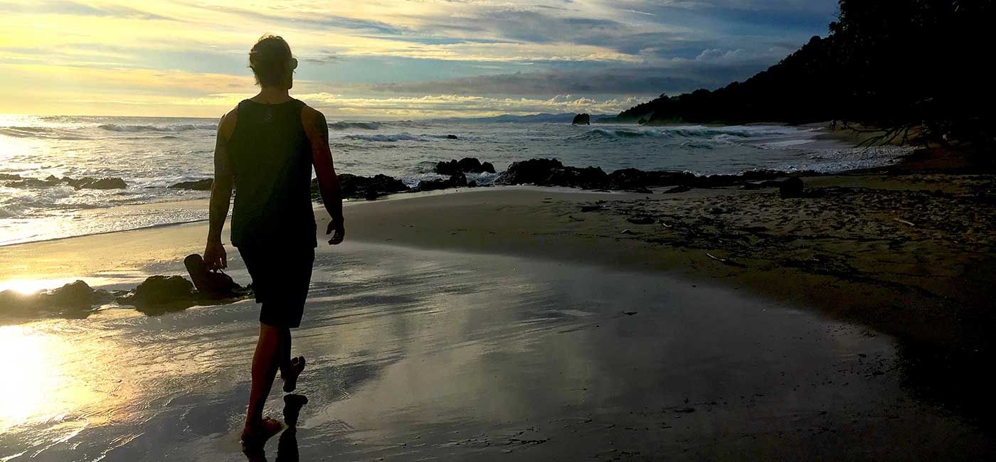 Mike Fitch walks alone on beach