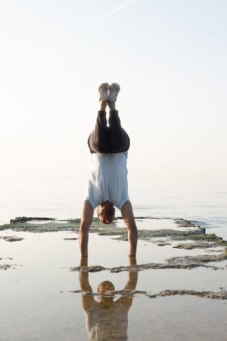 Master Instructor Roshan Chopra performs a Tuck Balance